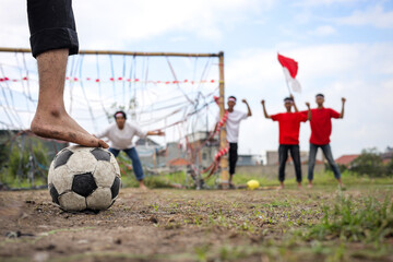 Close Up Of A Barefoot Soccer Player Preparing To Kick The Ball Celebrating Indonesian Independence.