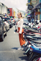 A beautiful teenage model girl posing on the streets of old town during street style photo shooting