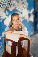 A beautiful teenage model girl posing on the streets of old town during street style photo shooting