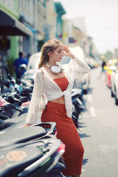 A beautiful teenage model girl posing on the streets of old town during street style photo shooting
