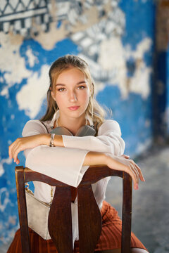 A beautiful teenage model girl posing on the streets of old town during street style photo shooting