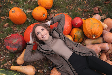 Beautiful happy girl lies on pumpkin in autumn. halloween
