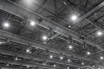 HVAC Duct Cleaning, Ventilation pipes in silver insulation material hanging from the ceiling inside new building.
