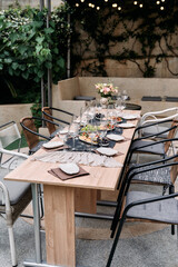 Elegant Outdoor Dining Table Set for a Memorable Gathering Surrounded by Lush Greenery and Warm Ambiance Ideal for Intimate Celebrations or Family Dinners