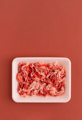 pork scraps in a food tray of polystyrene foam. 発泡スチロールの食品トレーに入った豚のこま切れ