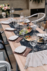 Elegantly Set Dining Table Featuring Gourmet Cuisine, Stylish Tableware, and Beautiful Floral Arrangement for Memorable Gatherings and Celebrations