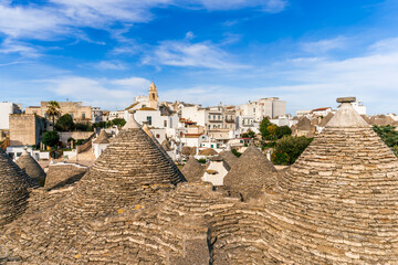 Fototapeta premium mediterranean vintage architecture with old tile roofs with white walls and beautiful high peaks on blue cloudy sky background