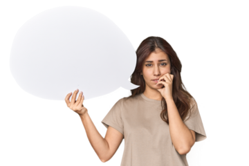 Middle Eastern woman holding comic bubble biting fingernails, nervous and very anxious.