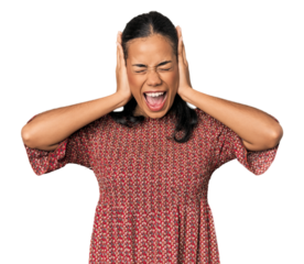 Young Filipino woman in studio covering ears with hands trying not to hear too loud sound.