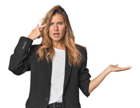 Young businesswoman in a suit holding and showing a product on hand.