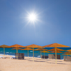 sun umbrella in sandy sea beach at the summer sunny day
