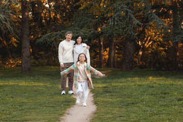 Fototapeta premium happy family walking in autumn park. autumn