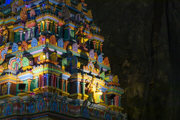 View of vibrant colors dance across the detailed facade of a Hindu temple Batu Cave against the dark cave, a cultural gem, Kuala Lumpur, Federal Territory of Kuala Lumpur.