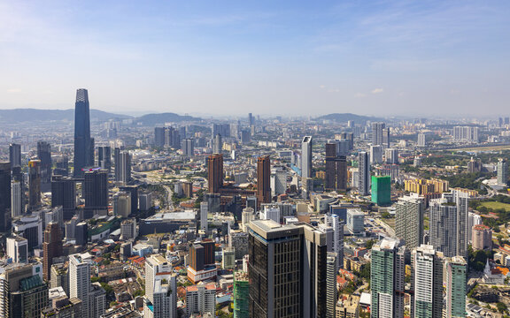 View of skyscrapers piercing the sky, an urban tapestry woven with modern architecture and bustling city life, Kuala Lumpur, Federal Territory of Kuala Lumpur.