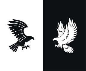 Obraz premium Contrasting Eagle Silhouettes in Attack Pose Bold Black & White Variations