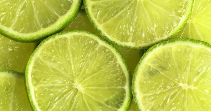 Lime slices close-up on a rotating table, top view.