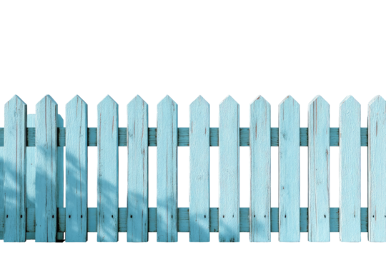 Light blue painted wooden fence with peaked tops, casting shadows