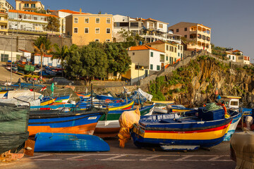 Picturesque fishing village of Camara de Lobos, Madeira, with colorful boats, coastal cliffs, and traditional charm under the Atlantic sun.