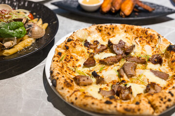 Pork topping pizza served on plate