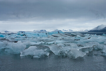 Glacier and icebergs in the cold, frozen, blue waters of an Antarctic landscape, Jokulsarlon Glacier Lagoon in Iceland