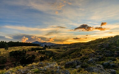 Fototapeta premium Stunning sunset over hilly landscape