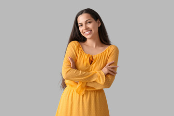 Cheerful young woman on grey background