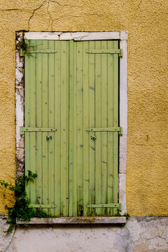 Paris, France, Europe.  The famous and worlds largest flea market - the St. Ouen "Marche des Puces.Weathered old green door.