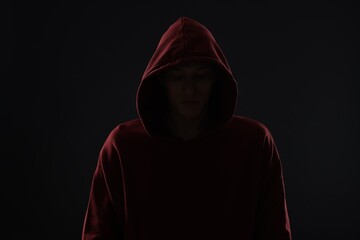 Anonymity. Man hiding his face in darkness