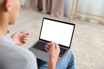 Man having online consultation with doctor via laptop at home, closeup