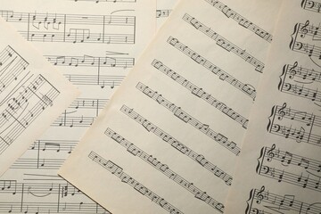 Obraz premium Sheets with musical notes as background, top view