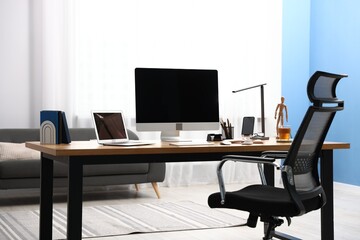 Stylish workplace with modern computer on desk indoors