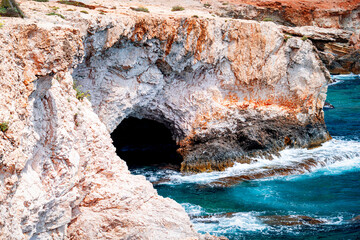Rocky coast of Cyprus with caves and the turquoise Mediterranean Sea, Ayia Napa, Cape Greco.