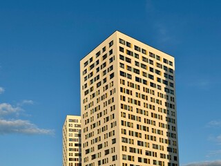 Apartment building on the background of blue sky, new building. High quality photo