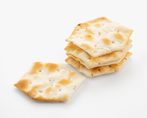Whole grain crackers with spices and herbs isolated on white background. Dry salted cookies with crackers. Stack of various crispy wheat, rye and corn tortillas with sesame and sunflower seeds