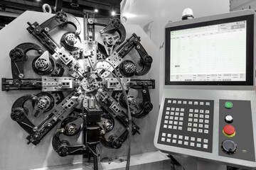 Automatic wire bending machine, High precision CNC machining center working, operator making automotive spring part process in factory.