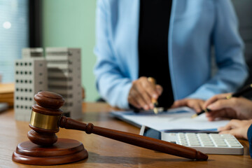 Justice and law concept. Real Estate Law in a courtroom the gavel, working with digital tablet...