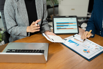 Businessman team or financial data analysts working with laptop and calculator show increase market share, growth of profit investment at home office.