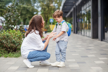 Happy mother encouraging son on school day