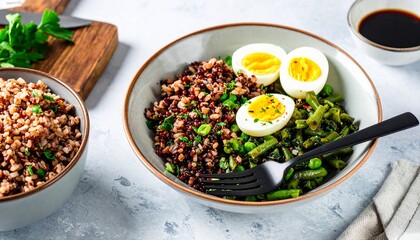Nutritious grain bowl with a hard-boiled egg and green beans, a concept of healthy eating and balanced diet.
