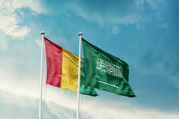 Guinea Saudi Arabia friendship flags are waving in the sky. Two country flag for agreement or deal. Guinea KSA national flag for commitment.
