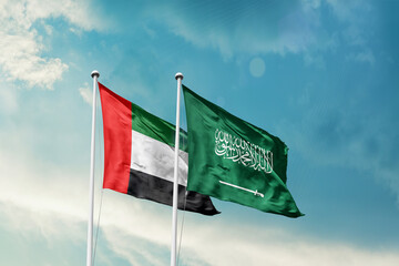 United Arab Emirates Saudi Arabia friendship flags are waving in the sky. Two country flag for agreement or deal. UAE KSA national flag for commitment.