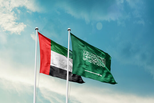 United Arab Emirates Saudi Arabia friendship flags are waving in the sky. Two country flag for agreement or deal. UAE KSA national flag for commitment.