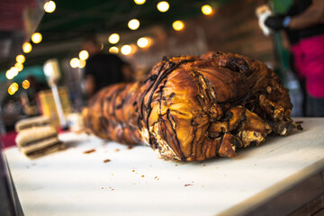 Delicious porchetta resting on cutting board at italian food market