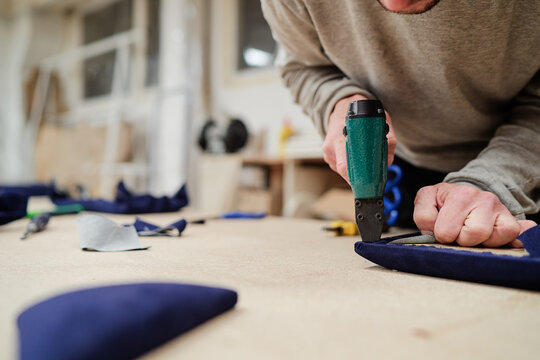 Close-Up of Craftsperson Working With Upholstery Fabric and Tools