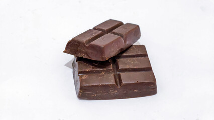 Two dark chocolate bars stacked, showcasing rich brown color and distinct segments.
