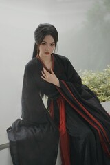 Elegant young woman in traditional black attire.