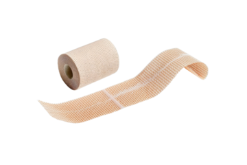 Medical bandage roll and an unrolled strip on a clean surface for first aid supplies