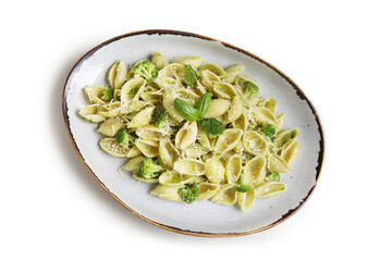 Plate of delicious conchigile rigate pasta with broccoli and basil leaves on grey background