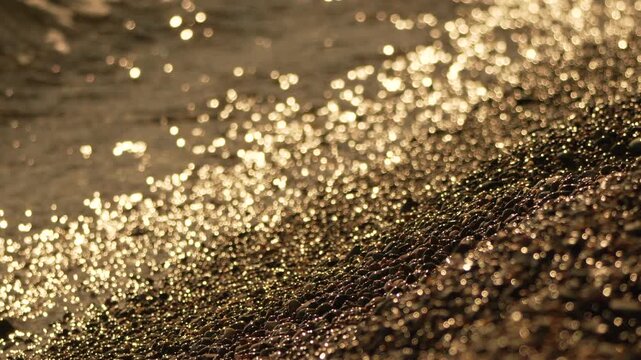 Gold Dust Beach Sand Texture Closeup: Sunlight reflection, coastal area, natural beauty.