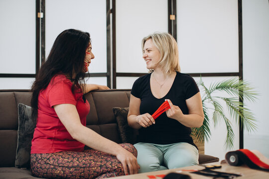 Physiotherapist applying kinesio tape to patient's face